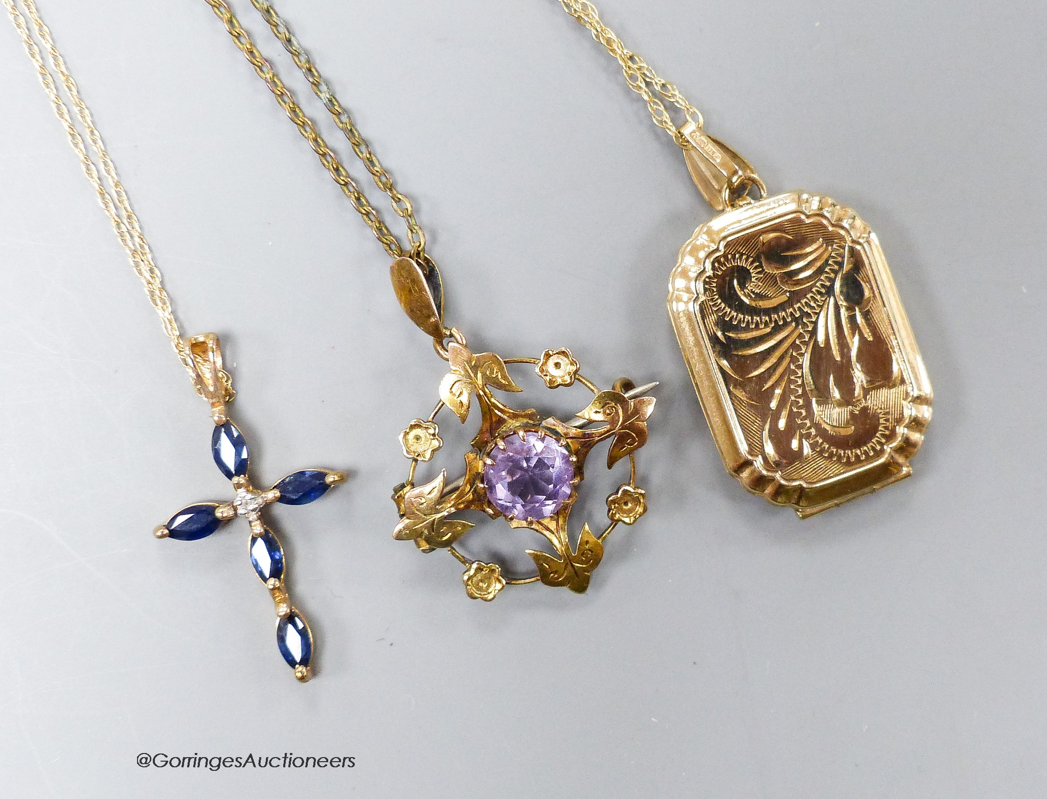 A 9ct gold locket on a 9k chain, a 9k sapphire and diamond set cross pendant and a 9ct amethyst pendant on a gilt metal chain.